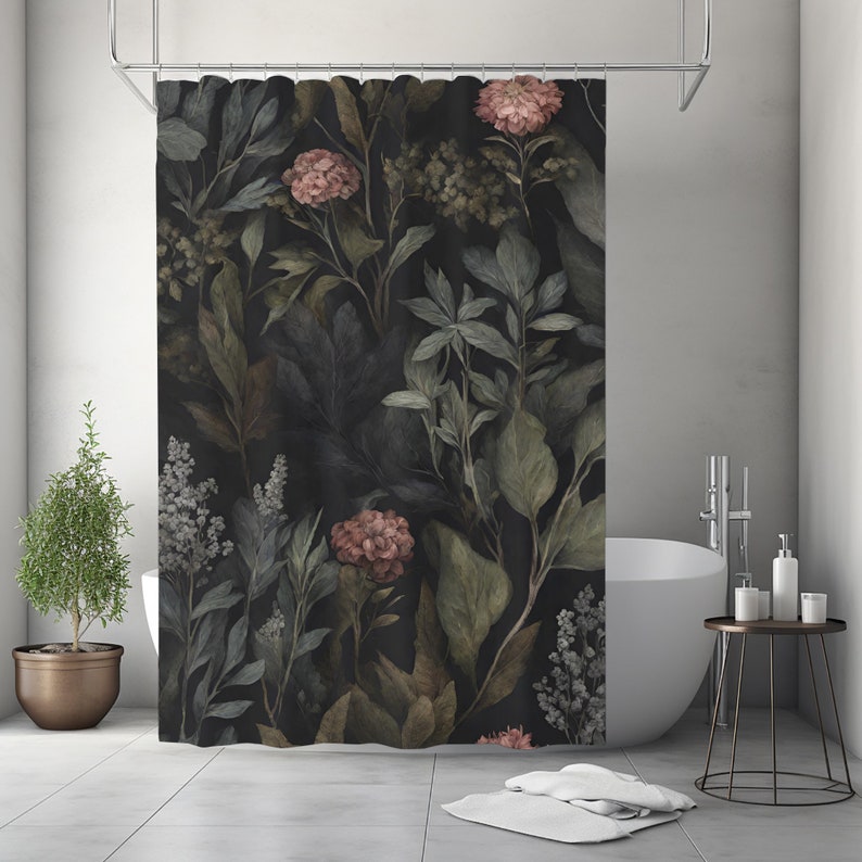 May include: A dark shower curtain featuring a botanical design with large leaves and flowers in shades of green, brown, and pink. The curtain is hanging in a bathroom with a white tub and a small potted plant.