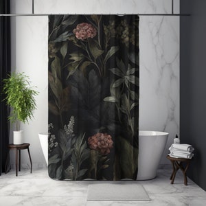 May include: A dark shower curtain featuring a botanical design with large leaves and flowers in shades of green, brown, and pink. The floral pattern is set against a black background. The curtain is hanging in a bathroom with a white tub and marble tile.