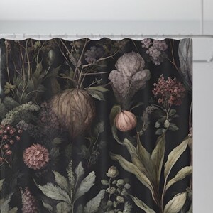 May include: A dark floral shower curtain with a black background and a variety of pink, purple, and green flowers. The flowers are arranged in a random pattern and are surrounded by leaves.