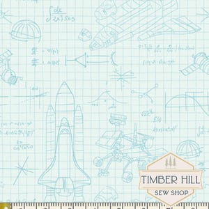 May include: Light blue fabric with a grid pattern and space-themed illustrations. The design includes rockets, satellites, and mathematical equations. The fabric has a ruler along the bottom, with measurements in inches.