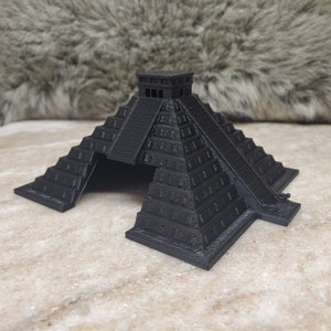 May include: A black 3D printed model of a Mayan pyramid with a stepped design and a small structure at the top.