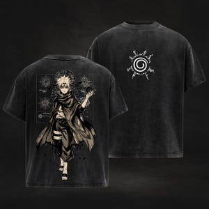 May include: Two black graphic t-shirts. One features a detailed anime character illustration on the back and a circular design on the front. The other shirt displays a white spiral design. Both shirts have a vintage, washed appearance.