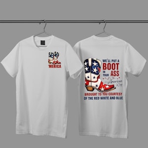May include: White t-shirts with a patriotic design. One shirt features a cowboy boot with a red, white, and blue American flag design, and the text "WE'LL PUT A BOOT IN YOUR ASS...The American Way." The other shirt has a smaller boot design and the word "'MERICA."