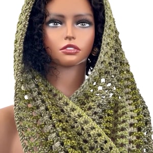 May include: A green and brown crocheted cowl with a hood. The cowl is made with a lacy stitch pattern.