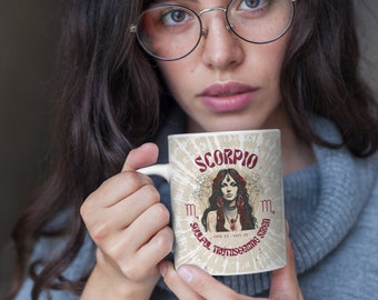 May include: A white ceramic mug with a brown and red design featuring the zodiac sign Scorpio. The mug has the text "Scorpio" and "Soulful Truthseeking Siren" in red lettering. The mug also has the dates "Oct 23 - Nov 21" printed on it.