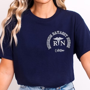 May include: A navy blue t-shirt with a white graphic that says "Minimum Dataset Nurse" with a caduceus symbol and the letters "RN" and the name "Celestine".