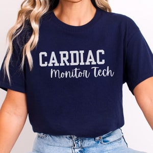 May include: A navy blue t-shirt with the text "CARDIAC Monitor Tech" in white lettering.