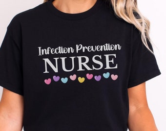 May include: Black t-shirt with the text "Infection Prevention NURSE" in white with a row of colorful hearts below the text.