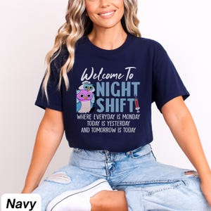May include: A navy blue t-shirt with a graphic of two owls and the text "Welcome To Night Shift" with the tagline "Where everyday is Monday, today is yesterday and tomorrow is today".