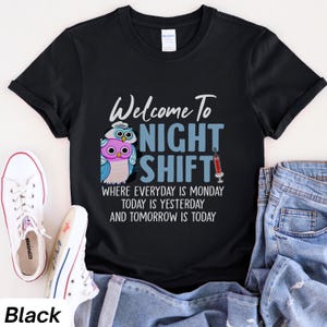 May include: Black t-shirt with a graphic of two owls and the text "Welcome to Night Shift" with the tagline "Where everyday is Monday, today is yesterday and tomorrow is today".