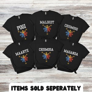 May include: Six black t-shirts with white text and a yellow, red, and blue star design. The text on the shirts reads "POGI", "MALIKOT", "CHISMOSO", "MAARTE", "CHISMOSA", and "MAGANDA". The text "ITEMS SOLD SEPARATELY" is at the bottom of the image.