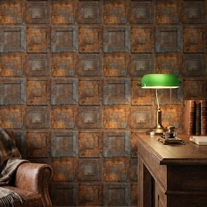 May include: A wall covered in square panels with a distressed, rusty metal appearance. The panels are a mix of orange and gray, creating a vintage industrial aesthetic. A desk with a green lamp and books is in front of the wall.