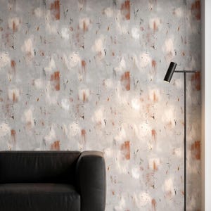 May include: Wallpaper featuring an abstract pattern with soft gray, white, and terracotta brushstroke accents. The design includes scattered dark specks and thin lines across a textured background, creating a layered visual effect on the wall.