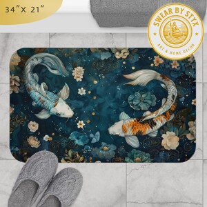 May include: A blue and gold bath mat with a floral design and two koi fish swimming in opposite directions. The mat measures 34 inches by 21 inches. The text "SWEAR BY STYX ART & HOME DECOR" is printed on the mat.