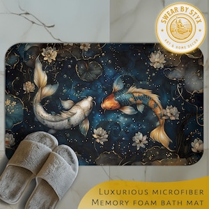 May include: A luxurious microfiber memory foam bath mat with a blue and gold design featuring two koi fish swimming in a pond with lily pads and flowers. The text "SWEAR BY STYX ART & HOME DECOR" is printed in gold on a yellow circle.