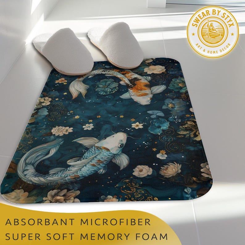 May include: A blue bath mat with a floral and koi fish design. The mat has a "Swear By Styx Art & Home Decor" logo in the top right corner. The text "Absorbant Microfiber Super Soft Memory Foam" is at the bottom of the image.