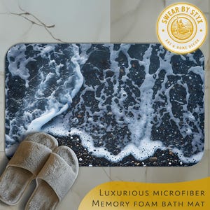 May include: A bathroom rug with a wave pattern on a dark blue background. The rug is made of microfiber and memory foam. The rug is placed on a white tiled floor. The text "SWEAR BY STYX ART & HOME DECOR" is in a yellow circle on the top right corner of the image.