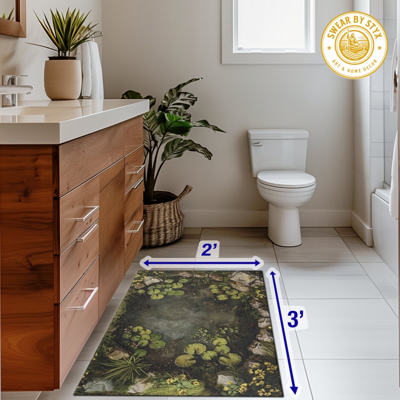 May include: A green and brown bathroom rug with a pond and lily pad design. The rug measures 2 feet by 3 feet.