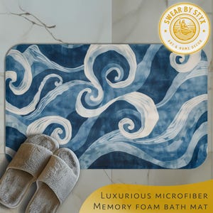 May include: Blue and white abstract swirl pattern bath mat with a soft, plush microfiber surface. The mat is made of memory foam and is designed to absorb water and provide comfort.