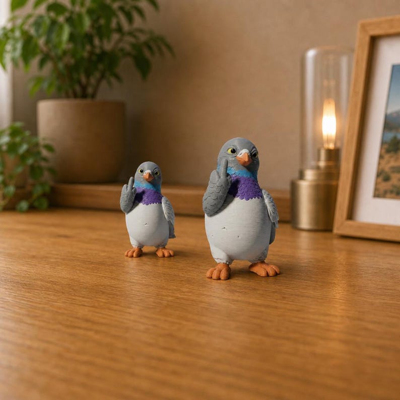 Small and large pigeon figurines standing together on a wooden surface, showing the size difference, orange feet and colorful neck feathers.