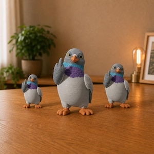 Three funny pigeon figurines in small, medium and large sizes, posed together with grey bodies, purple chests and raised middle fingers.