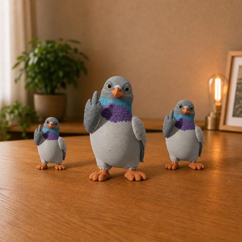 Three funny pigeon figurines in small, medium and large sizes, posed together with grey bodies, purple chests and raised middle fingers.