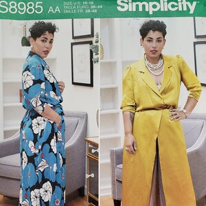 May include: Simplicity sewing pattern number S8985 AA for sizes US 10-18, Euro 36-44, and French 38-46. The pattern includes instructions for a long-sleeved wrap top with a floral print and a long-sleeved wrap coat in a solid yellow color. The pattern also includes a sew-along video with Mimi G on YouTube.