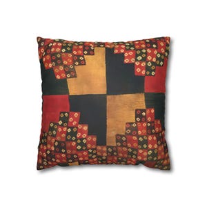 May include: Square decorative pillow with a patchwork design. The pillow features a geometric pattern with squares of black, red, and gold fabric. The red squares are decorated with small diamond shapes in red, black, and gold.