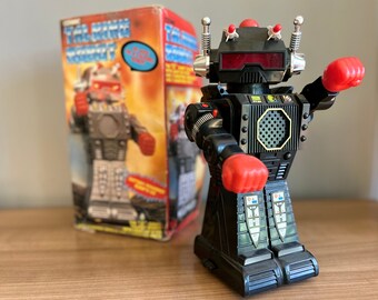 Cosmic Talking Robot from the 80s, talks by pressing his head, walks, bump'n go, and fires missiles and his two fists. Robot 12"