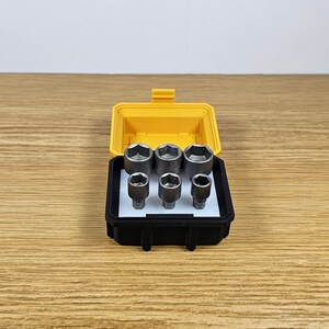 May include: A yellow and black plastic case with a set of six black socket wrenches.