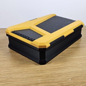 May include: A yellow and black storage box with the text "SMART STORAGE" printed on the top.