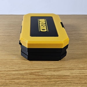 May include: A yellow and black plastic storage box with the word "CUSTOM" printed on the top.