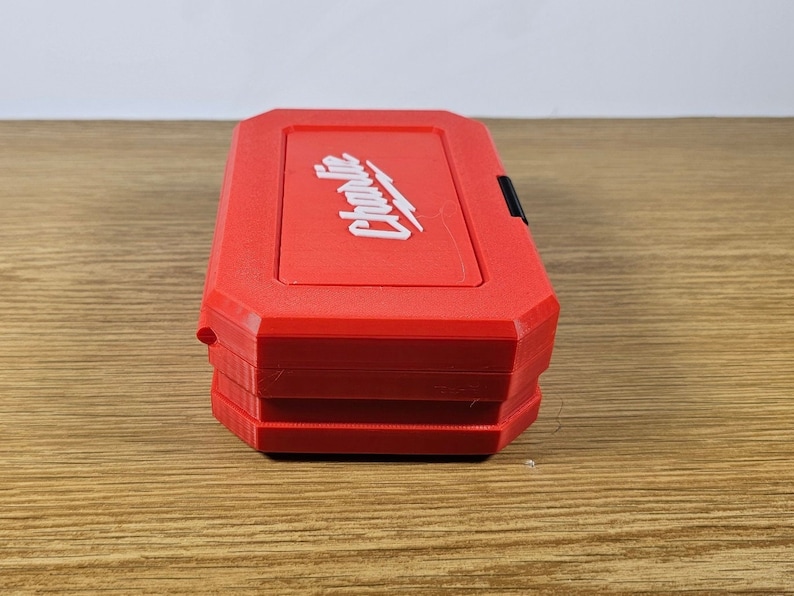May include: A red plastic tool box with the word "Craftsman" printed in white on the top. The box has a black latch.