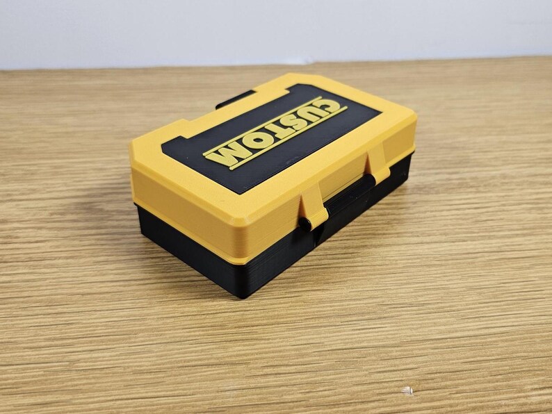 May include: A small yellow and black plastic toolbox with the word "CUSTOM" printed on the lid.
