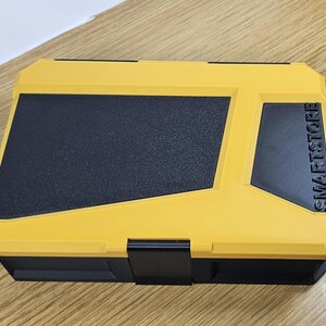 May include: Yellow plastic storage box with a black lid and a black label that says "SMARTSTORE".