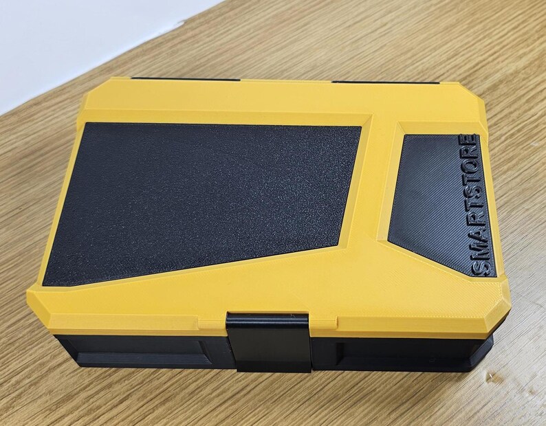 May include: Yellow plastic storage box with a black lid and a black label that says "SMARTSTORE".
