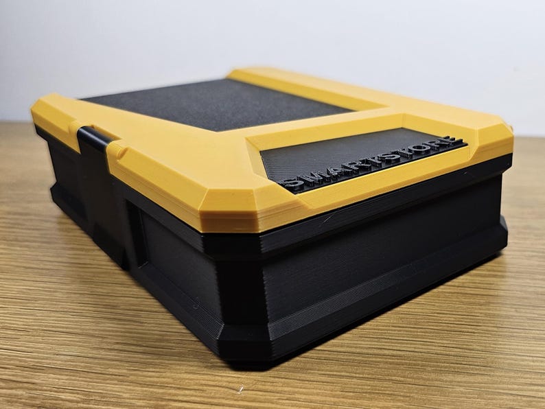 May include: A yellow and black plastic storage box with the text "SMARTSTORE" printed on the top.