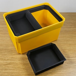 May include: A yellow plastic storage box with a black removable divider. The box is open and the divider is sitting next to it.