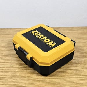 May include: A yellow and black plastic storage case with the word "CUSTOM" printed on the top.