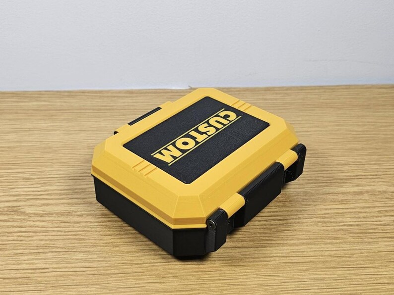 May include: A yellow and black plastic storage case with the word "CUSTOM" printed on the top.