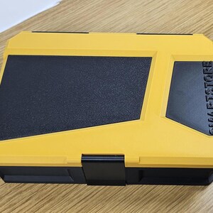 May include: A yellow and black plastic storage box with the word "SMARTSTORE" printed on the side.