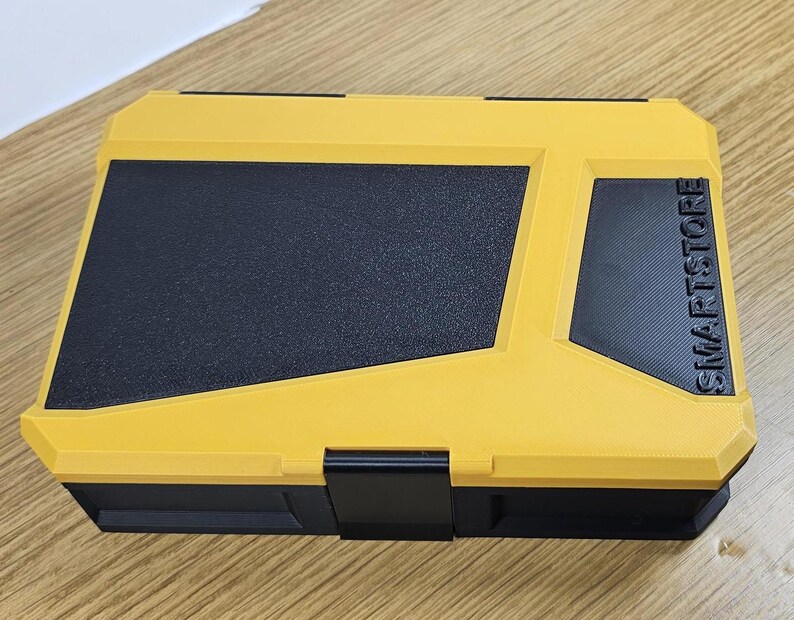 May include: A yellow and black plastic storage box with the word "SMARTSTORE" printed on the side.