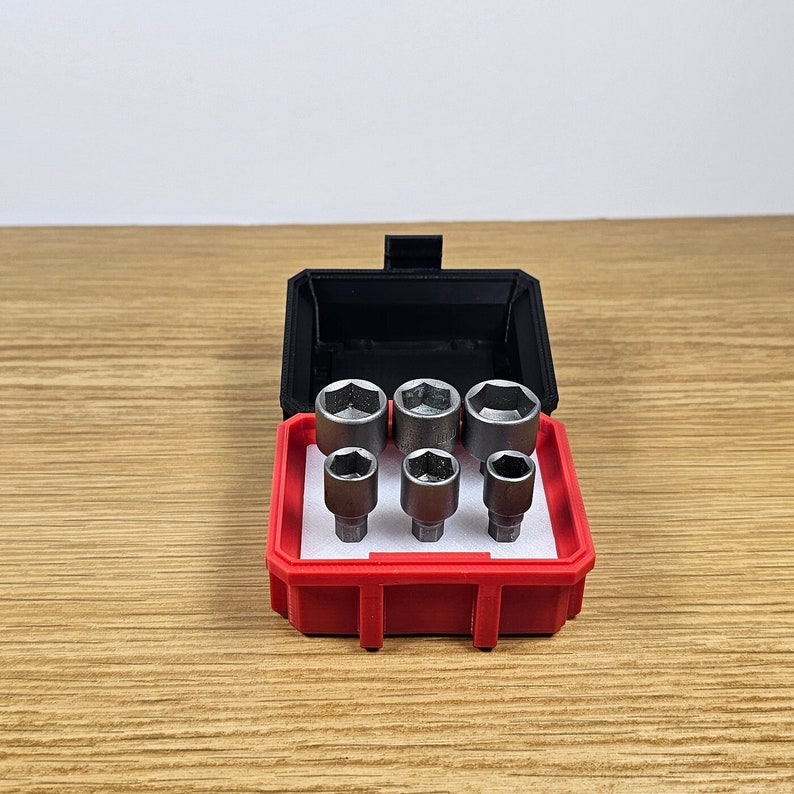 May include: A red and black tool case with six silver socket wrenches inside.