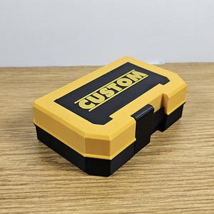 May include: A yellow and black plastic storage box with the word "CUSTOM" printed on the top.