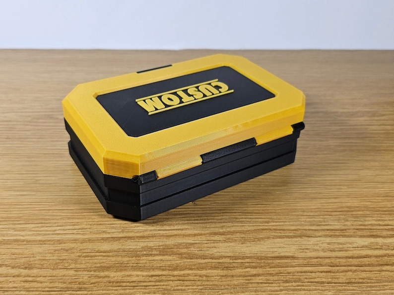 May include: A yellow and black plastic storage box with the word "CUSTOM" printed on the top.