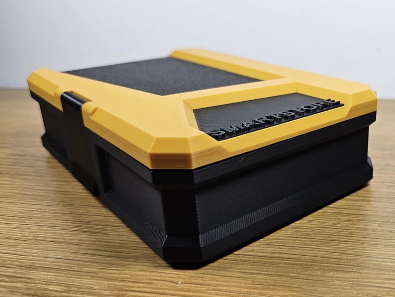 May include: A yellow and black plastic storage box with the word "SMARTSTORE" printed on the top.