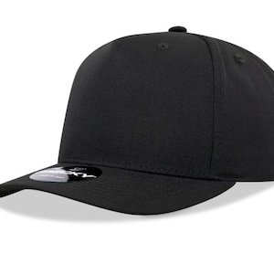 May include: A solid black baseball cap with a curved brim. The cap has a structured crown and a small, round button on top. A small, circular sticker is on the brim. The hat is made of a smooth, matte material.