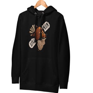 May include: Black hoodie with a graphic design featuring a map of Africa with the words "AFRICA" and "FROM" in a distressed font. The design incorporates various patterns and colors.