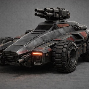May include: A dark gray armored combat vehicle with six large, rugged tires and a rotating turret featuring four mounted cannons. The vehicle has angular metal plating, red accent panels, and glowing orange front lights on the chassis.