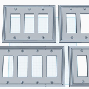 May include: A selection of light grey electrical switch plates in different arrangements. The plates feature rectangular apertures for switches and sockets, with decorative edges and screw holes. The image displays plates with one, two, and three openings.